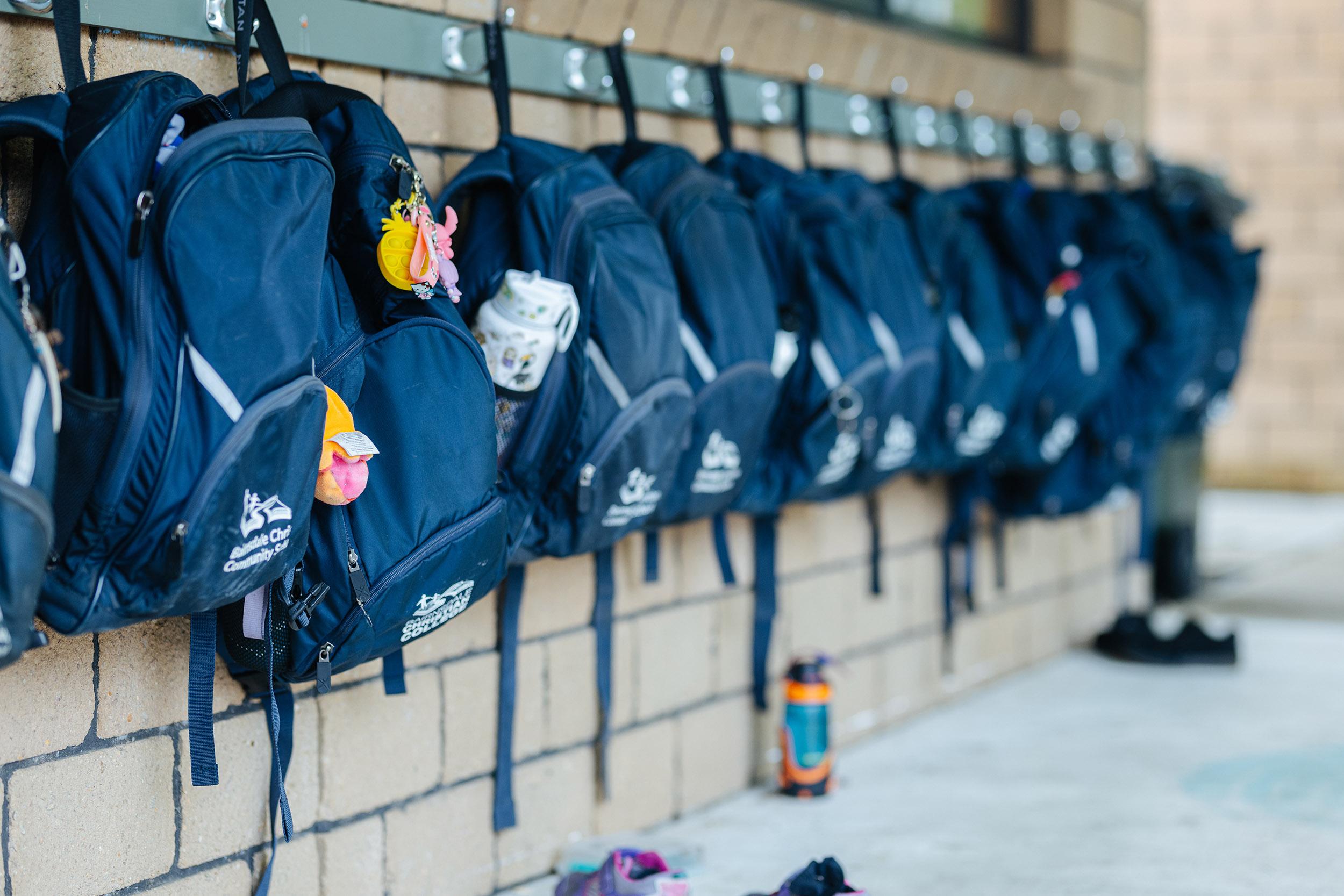 Primary school students smiling as they board a private school bus, showing safe and stress-free transport options at Bairnsdale Christian College.
